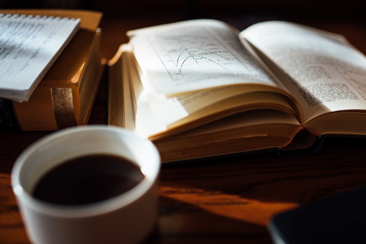 Old Hard Cover Archive Book With Notes And Coffee On Table.resea